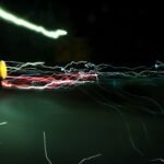 Abstract long-exposure shot of colorful light trails at night, a creative way to visually suggest the concept of electrical flow or negative voltage.