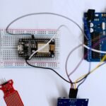 ESP8266 microcontroller wired on a breadboard with an Arduino UNO, ready to control a stepper motor.