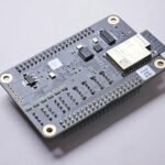 A close-up of an ESP32 microcontroller board, the core of a DIY weather station project.