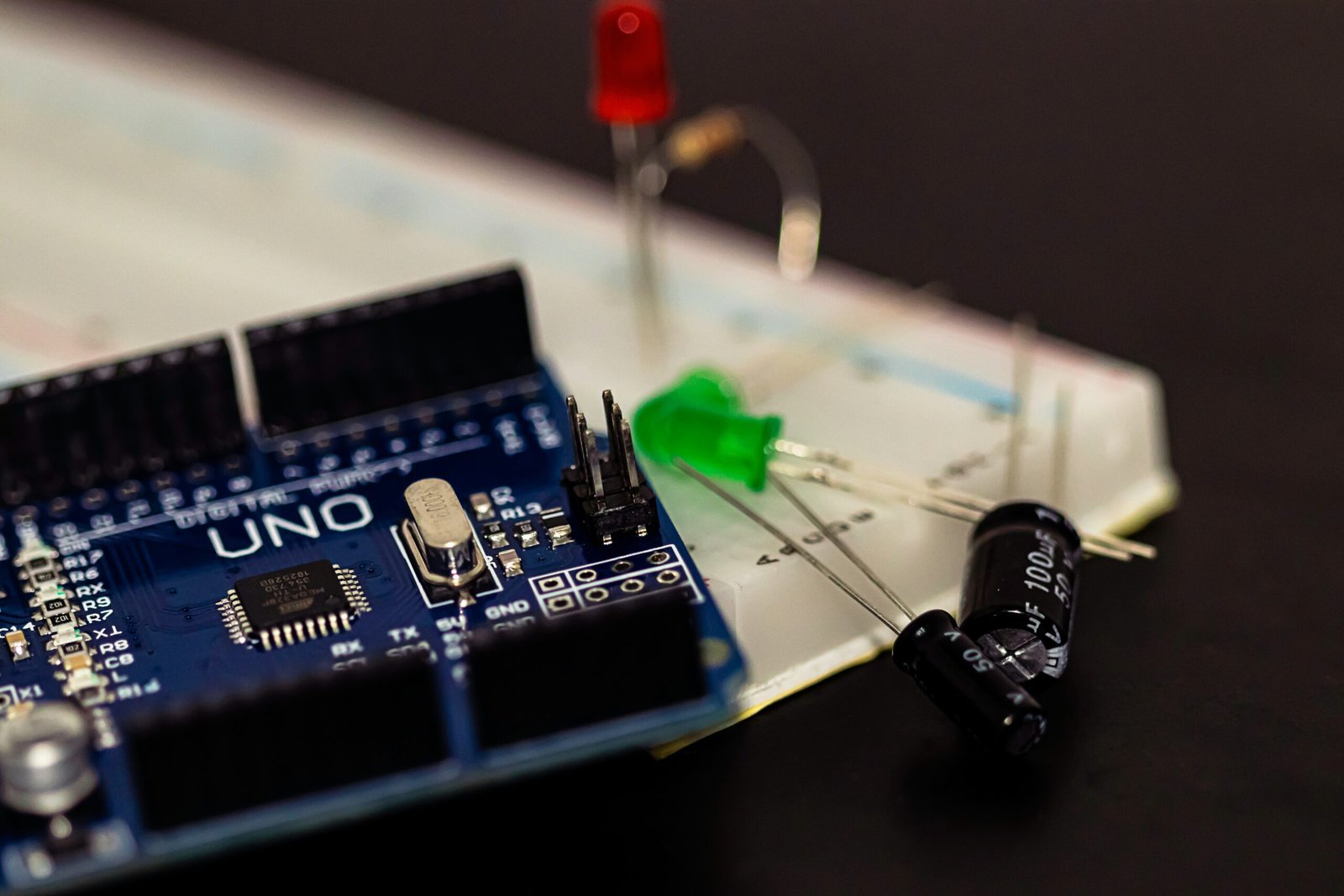 Simple Raspberry Pi Pico LED circuit in progress, with red and green lights connected to a breadboard for a basic blinking test.