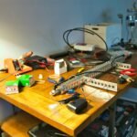 diy electronics projects workbench with tools and wires.