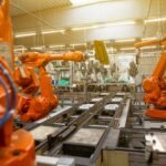 A sleek industrial robot arm in a modern factory, demonstrating advanced robotic arm design.