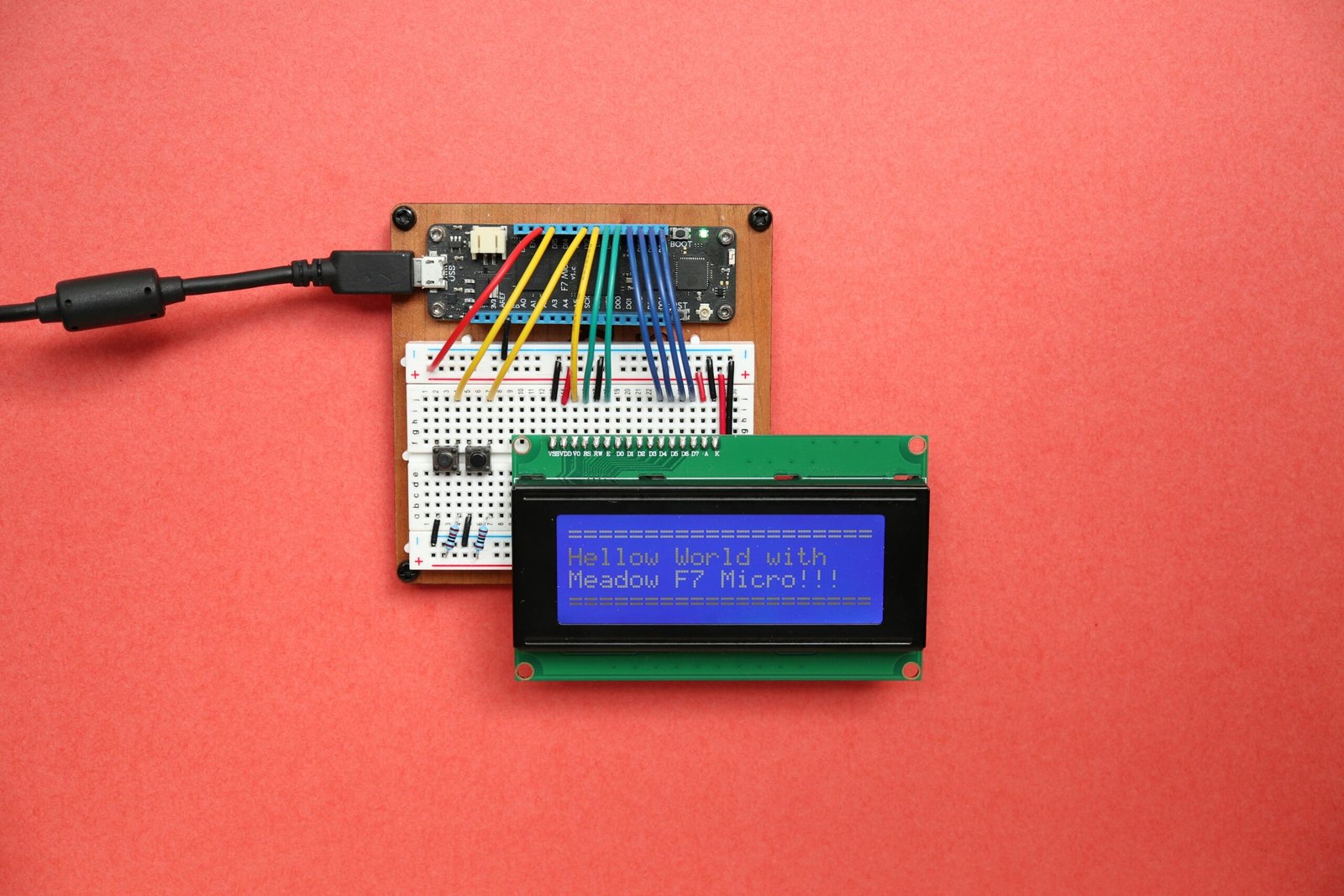 An LCD display connected to an Arduino microcontroller reading “Hello World,” part of an early stage voltage sensor test build.