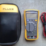 Fluke 115 digital multimeter with yellow holster and test leads, for a Fluke 117 vs 115 comparison